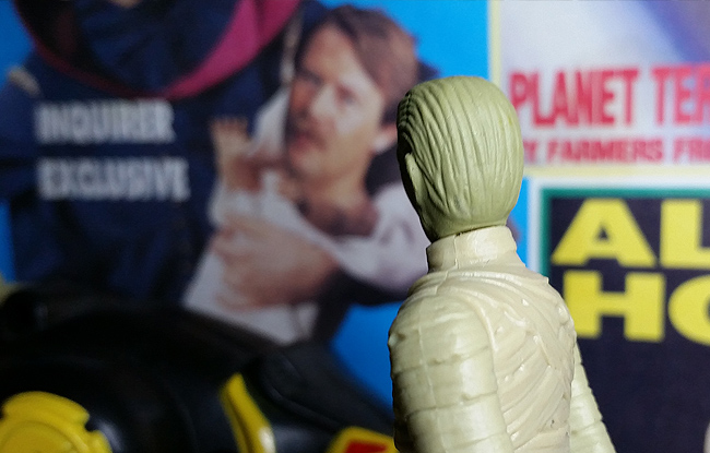 Mummy Brother looking at tabloid