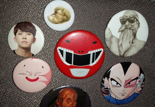 Pinback buttons of: K-Pop man, cat, Fat Buu, Saru, Red Power Ranger, Master Roshi, Vegeta